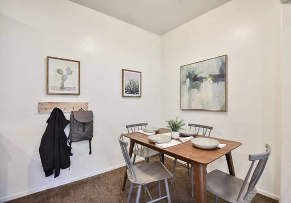 a dining room with a wooden table and chairs