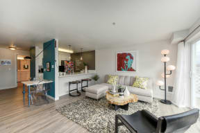 Living Room with with Hardwood Inspired Floor, Black Chair, Bar Seating and Black/White Rug