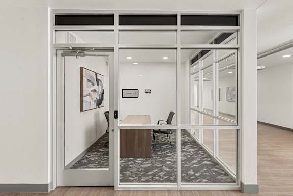Glass enclosed private office with desk and chair at Lucero Apartments, Phoenix, AZ, Arizona