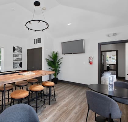 A modern dining room with a wooden table and chairs.