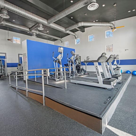 a large exercise room with treadmills and other exercise equipment  at Collective on Riverside, Austin, 78741