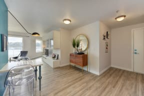 Entryway with Wood Inspired Floors, See Through Chairs and Windows