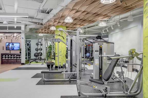 A gym with a variety of equipment including a leg press machine.