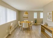 Thumbnail 4 of 8 - A dining room with a table and chairs.