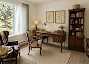 Thumbnail 4 of 8 - A room with a desk, chair, and bookshelf.