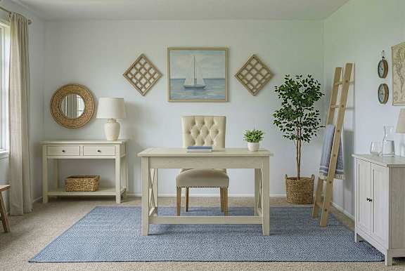 A white chair sits in front of a wooden desk with a blue rug underneath.