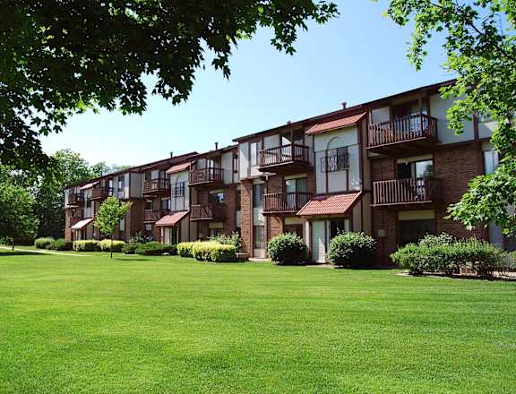 A row of apartment buildings with green lawns in front at Madeira Apartments, Kalamazoo, MI, 49001