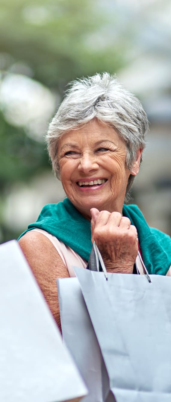 a couple of elderly women with shopping bags
