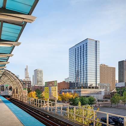A train station with a train on the tracks.