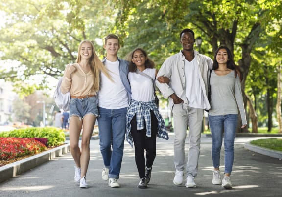 Friends walking and smiling together