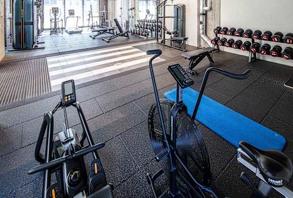 A gym with a stationary bike in the foreground.