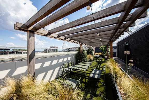 A wooden pergola with a bench underneath it.