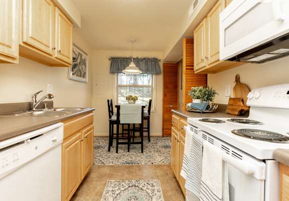 Fully equipped eat in kitchen with washer and dryer at Spring Hill Townhomes
