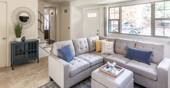 a living room with a couch and a coffee table at The Orchards at Severn Townhomes*, Severn, MD 21144