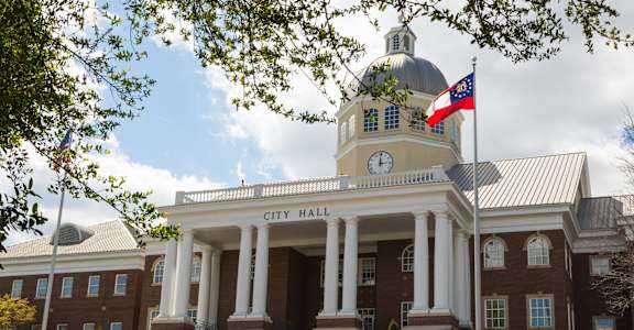 A large building with a dome and columns is labeled City Hall.