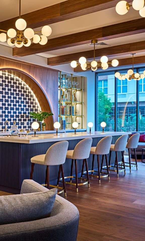 the lobby of a hotel with a bar and tables and chairs at Dey & Bergen, Harrison, 07029