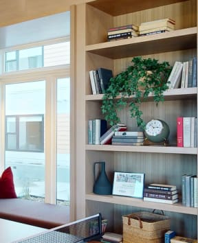 a window seat in a living room with bookshelves