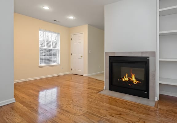 A modern living room with a fireplace and wooden floors.