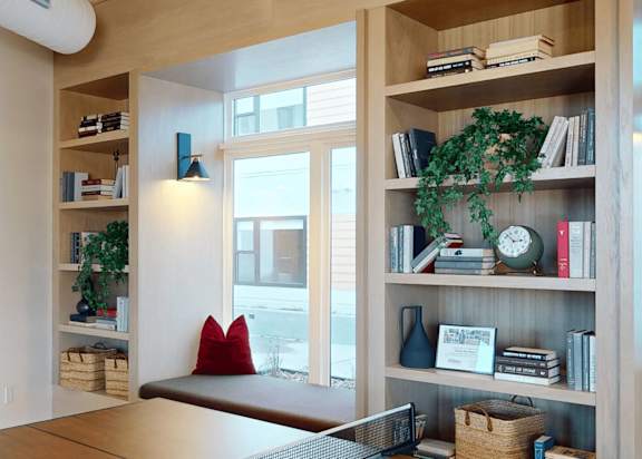 a living room with bookshelves and a window