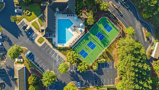 arial view of a house with a tennis court and a pool
