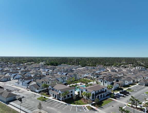 A large housing development with a clear blue sky above.