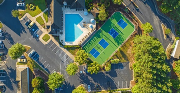 arial view of a house with a tennis court and a pool