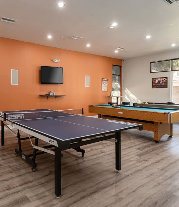 A room with a pool table and a TV mounted on the wall at Tivoli Apartments, Gainesville, 32608