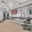 the gym is equipped with treadmills and weights at the apartments