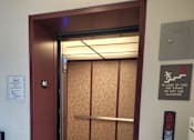 Thumbnail 6 of 34 - A small room with a fire escape sign on the wall.