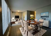 Thumbnail 1 of 8 - A modern dining room with a wooden table and chairs.