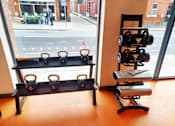 Thumbnail 15 of 16 - a rack of kettlebell weights in front of a window