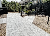 Thumbnail 15 of 16 - a courtyard with benches and trees and a black fence