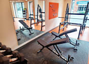 Thumbnail 14 of 16 - a gym with various exercise equipment on the floor and a window