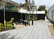 Thumbnail 13 of 16 - a small courtyard with benches and a table in front of a fence