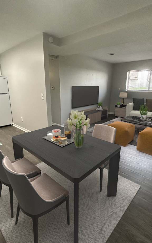 A modern kitchen with a dining table and chairs.