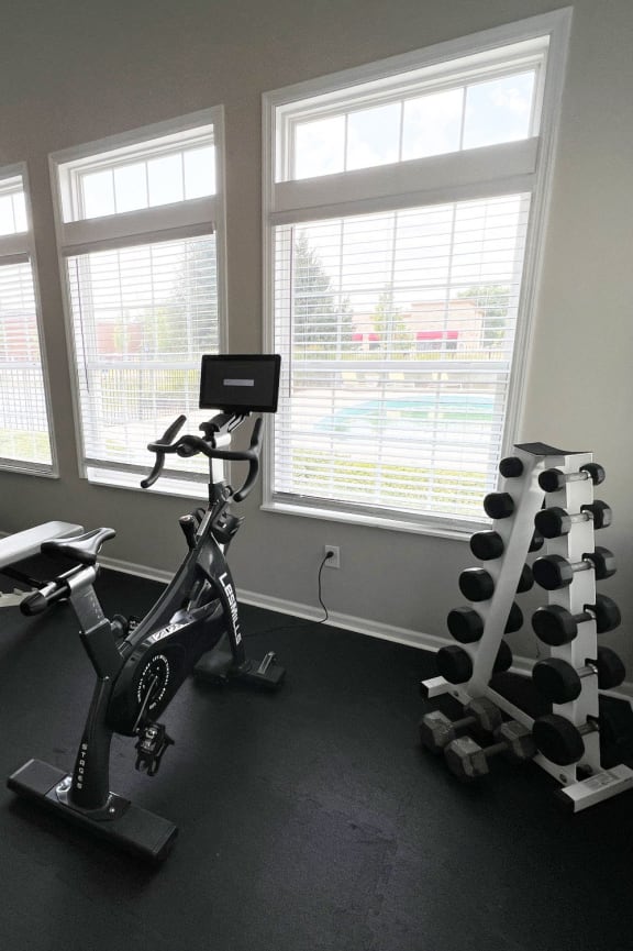 a gym with treadmills and exercise equipment at the preserve at polk apartments at Traditions at Slate Ridge, Ohio, 43068