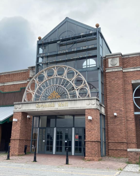 the front of a brick building with a glass entrance