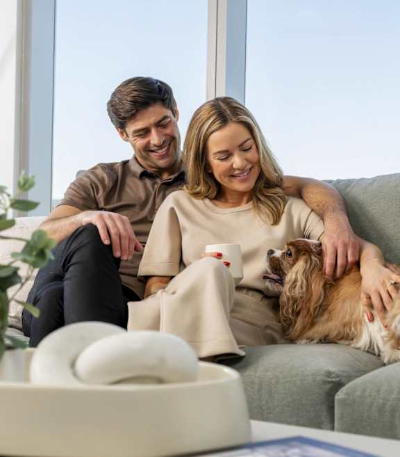 a man and a woman smiling at their dog