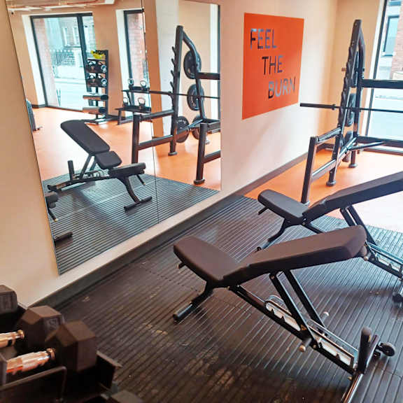 A gym with a sign that says "Feel the Burn".