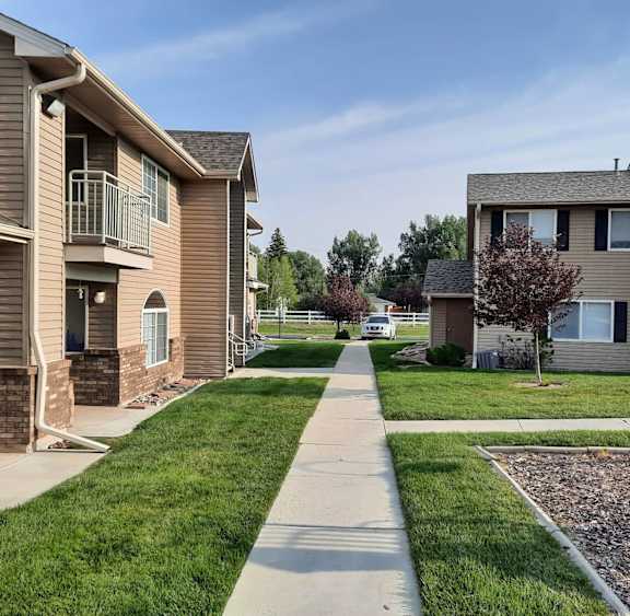 a view of a sidewalk between two apartment buildings