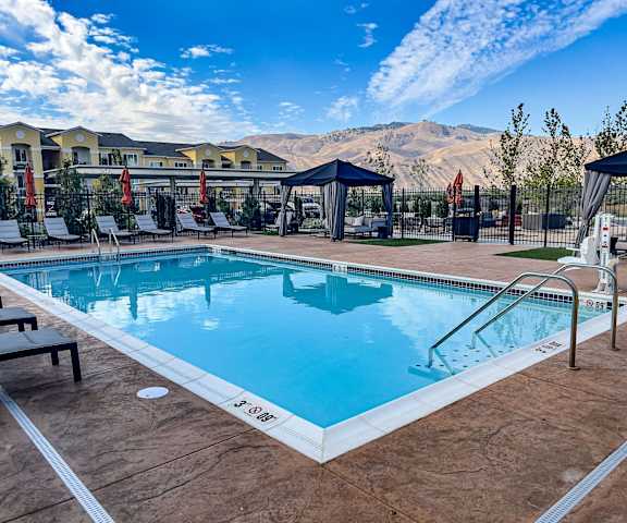 A large outdoor swimming pool with a mountain in the background.