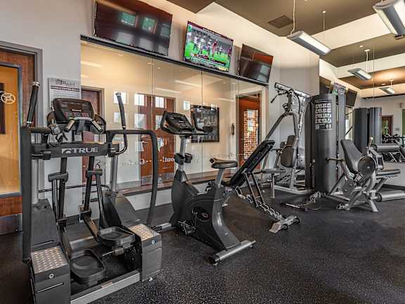 A gym with a variety of exercise equipment including treadmills, stationary bikes, and weight machines  at Bristol Station Apartments, Carteret, New Jersey