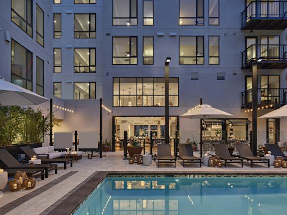 Resort-style pool with lounge chairs offering a relaxing environment at AVE Santa Clara, Santa Clara