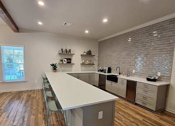 a view from above of a living room with a kitchen and a ceiling with wood
