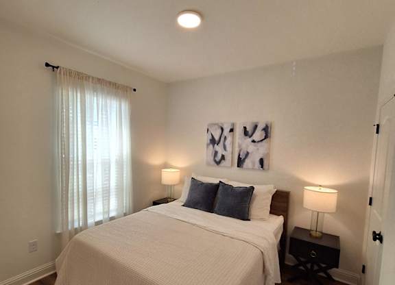 a bedroom with a bunk bed and a staircase with a window