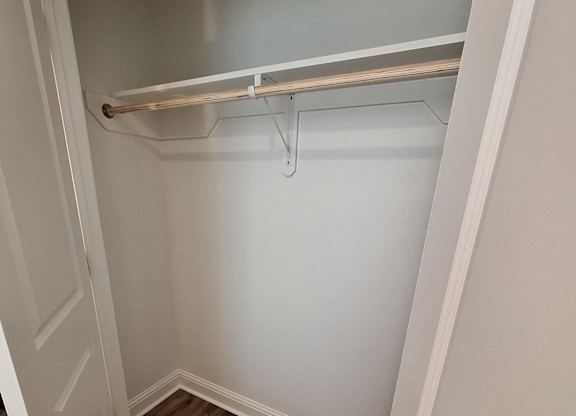 a small bathroom with a shower and a wooden floor