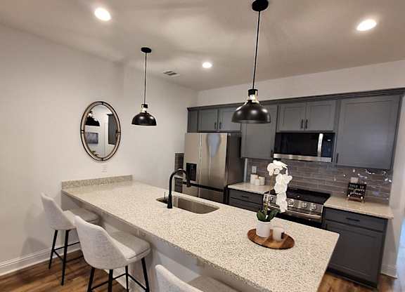 a view from above of a living room with a dining room table and a kitchen