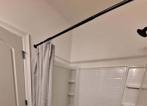 a small bathroom with a toilet and a walk in shower