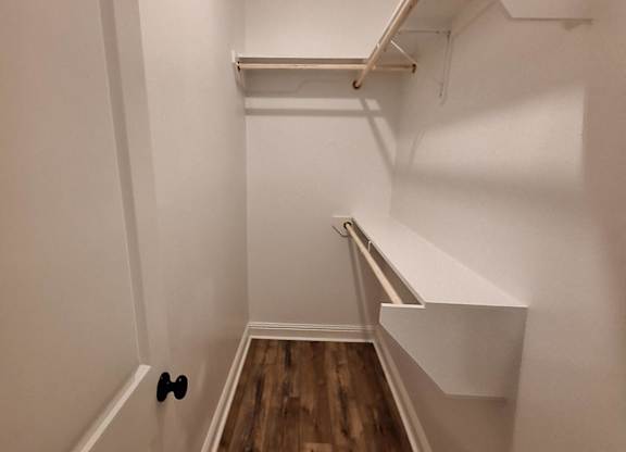 a large white room with a wooden wall and a white sink