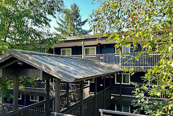 A house with a metal roof and a balcony.